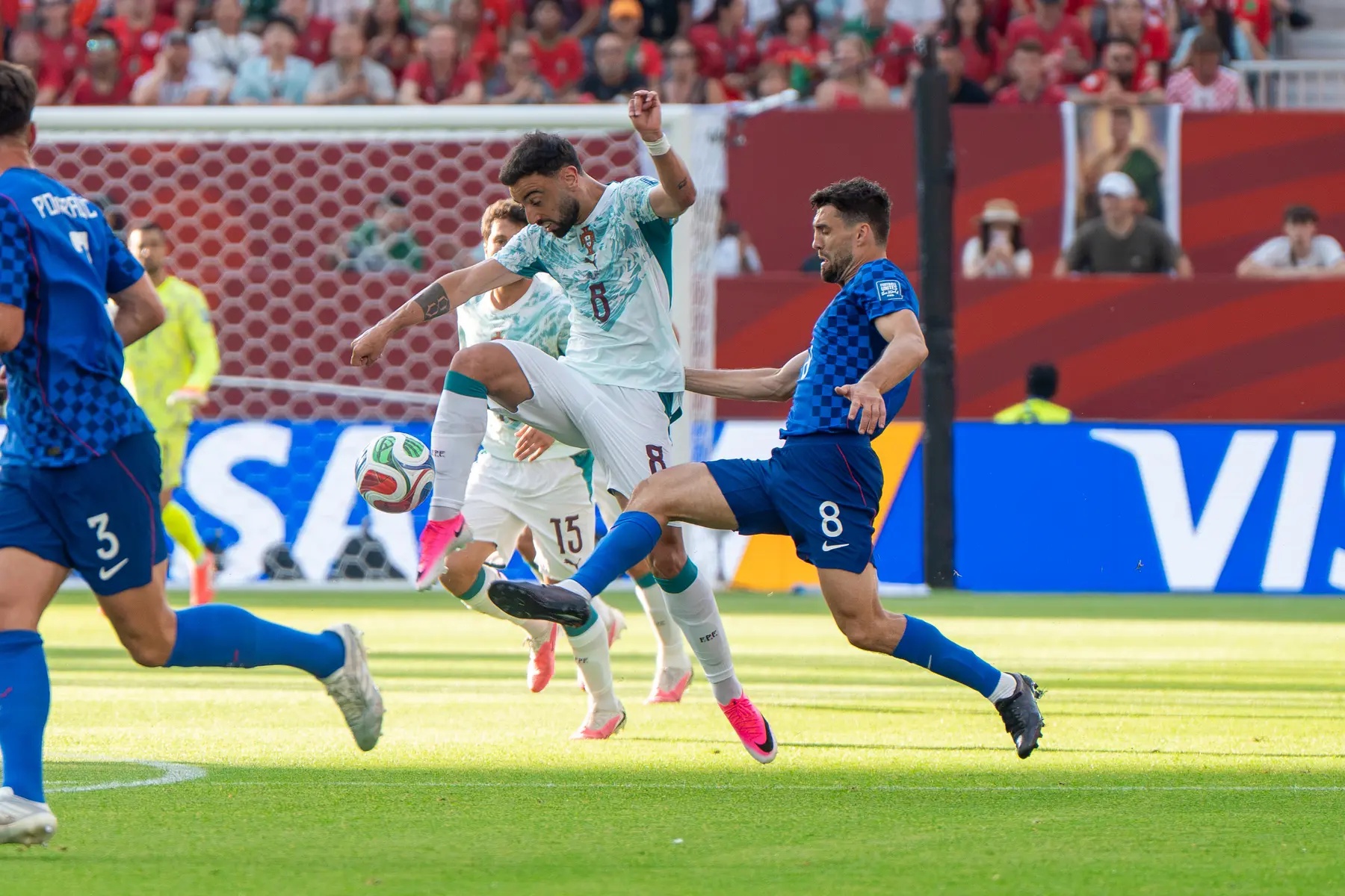 Bruno Fernandes of Portugal competing for the ball against a Croatia player during a match.