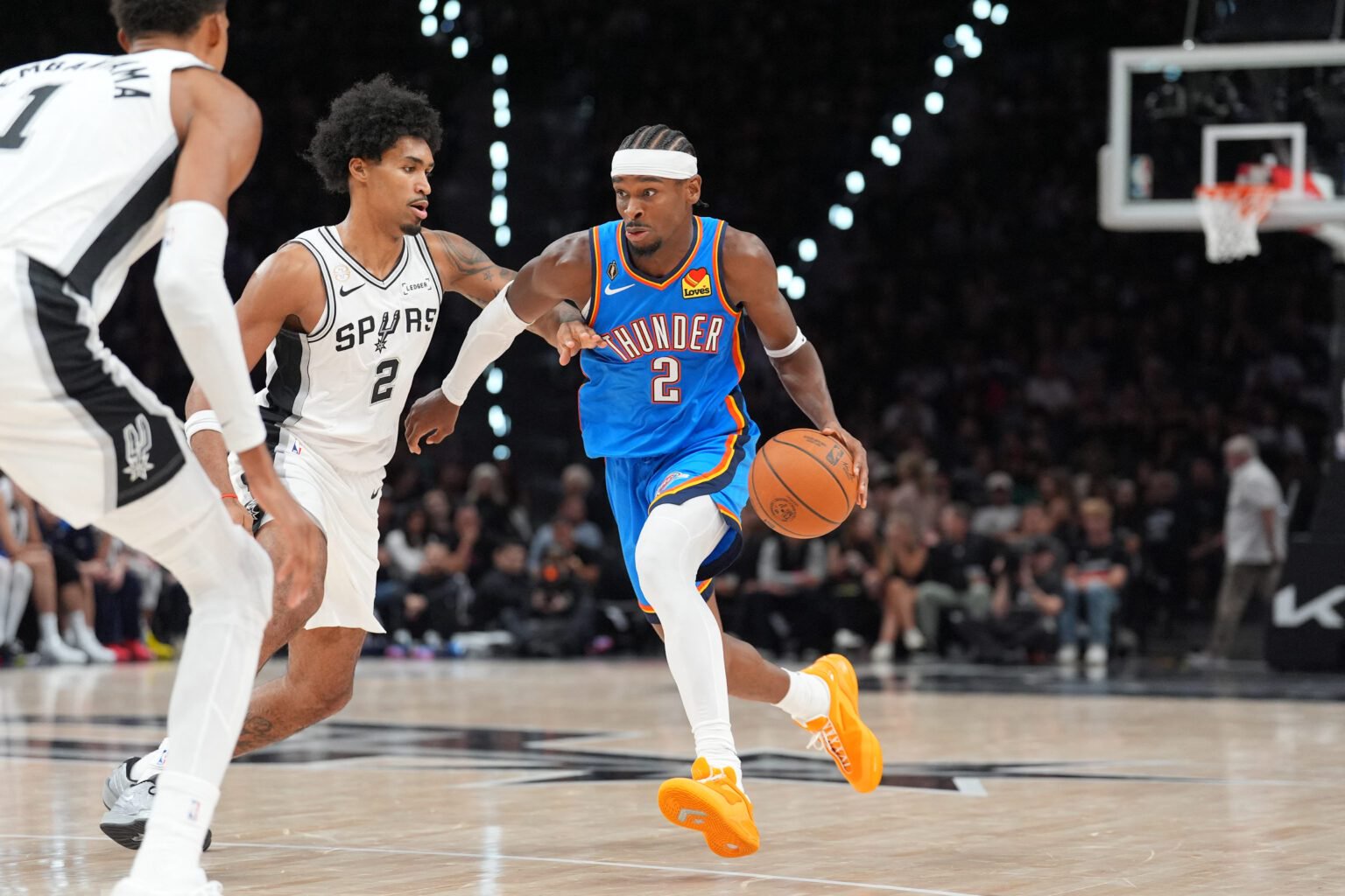 Oct 20, 2026; San Antonio, Texas, USA; Oklahoma City Thunder guard Shai Gilgeous-Alexander (2) dribbles against San Antonio Spurs guard Dylan Harper (2) in the first half at Frost Bank Center. Mandatory Credit: Daniel Dunn-Imagn Images