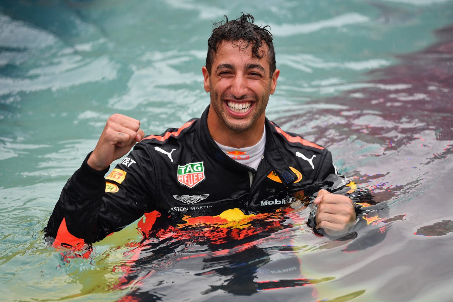 Daniel Ricciardo celebrating his win at the 2018 Monaco Grand Prix in the famous swimming pool.