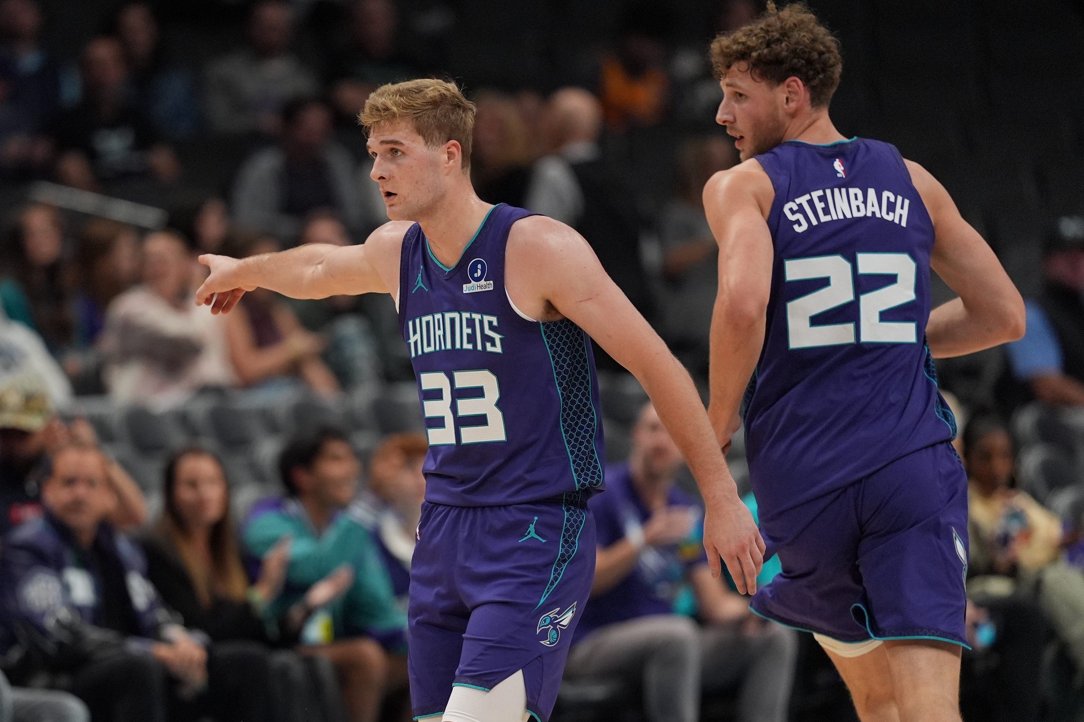 Oct 23, 2026; Charlotte, North Carolina, USA;  Charlotte Hornets guard Liam McNeeley (33) directs forward Hannes Steinbach (22) during the second half against the Atlanta Hawks at the Spectrum Center.  Mandatory Credit: Jim Dedmon-Imagn Images