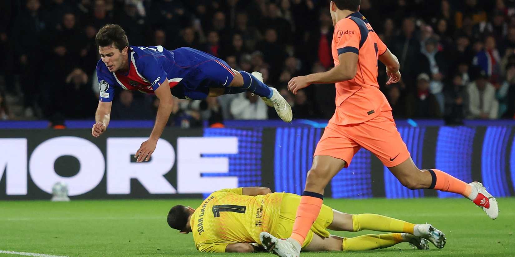 Joao Neves jumps over Joan Garcia in PSG vs Barcelona