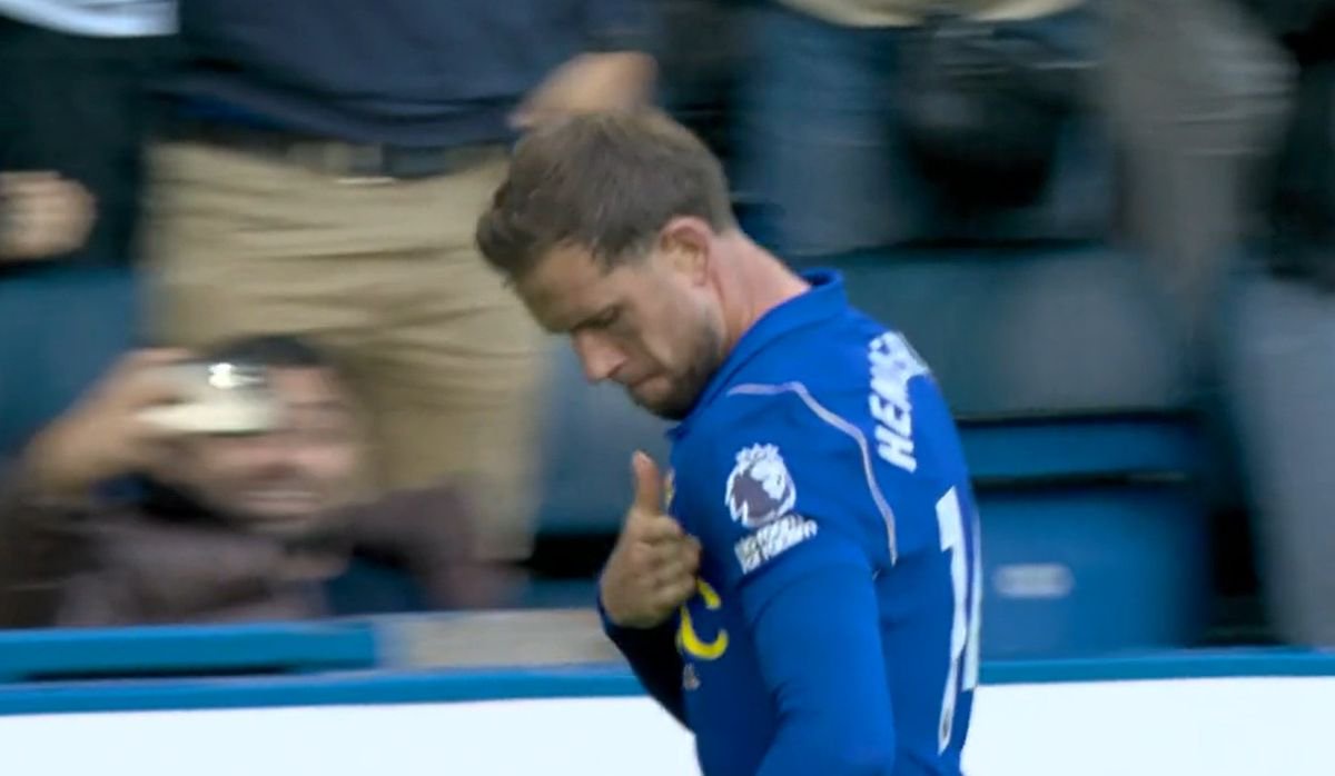 Jordan Henderson taps the Chelsea badge after scoring against Bournemouth