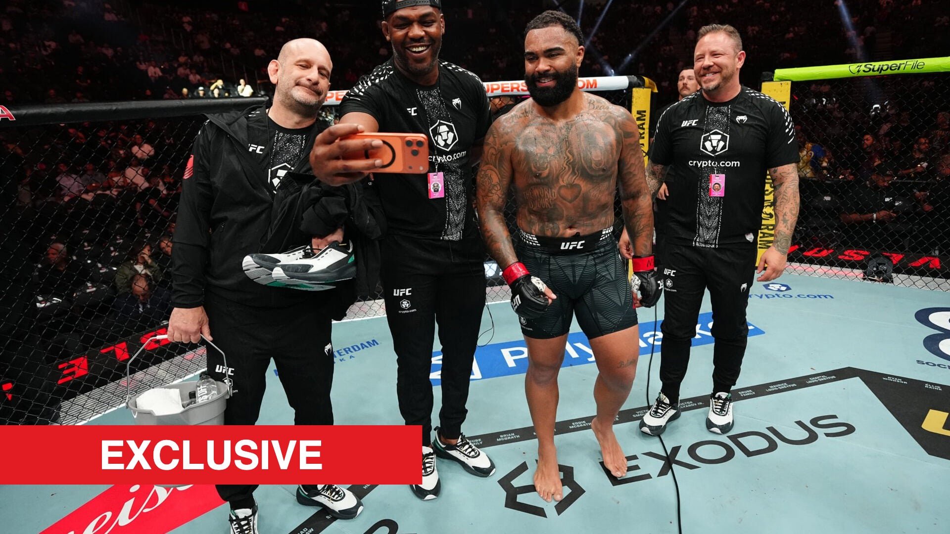 Jon Jones and Gable Steveson take a selfie with their team at UFC 329