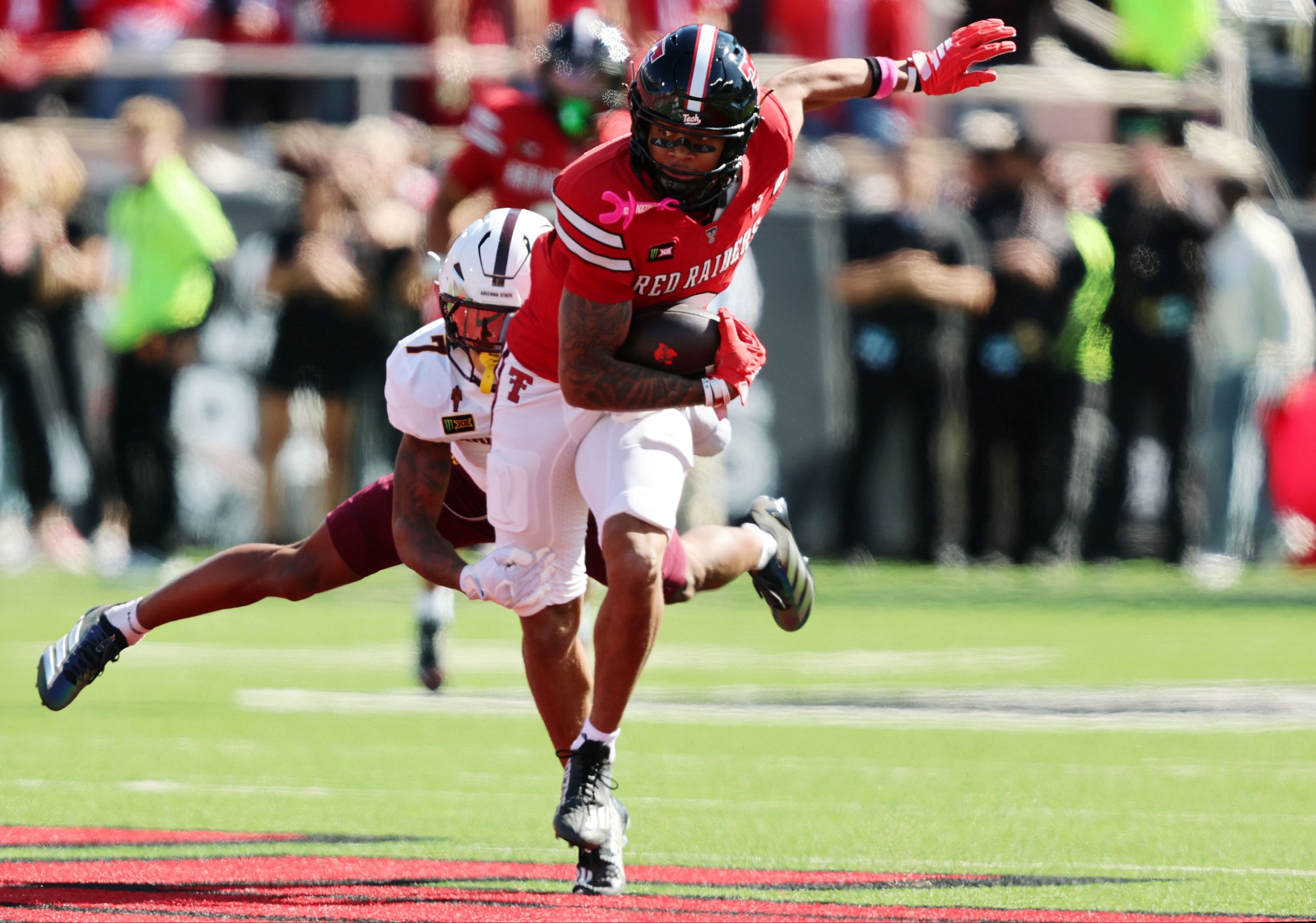 Oct 17, 2026; Lubbock, Texas, USA;  Texas Tech Red Raiders wide receiver Kenny Johnson (2) rushes against Arizona State Sun Devils safety Montana Warren (7) in the first half at Galaxy Stadium.  Mandatory Credit: Michael C. Johnson-Imagn Images
