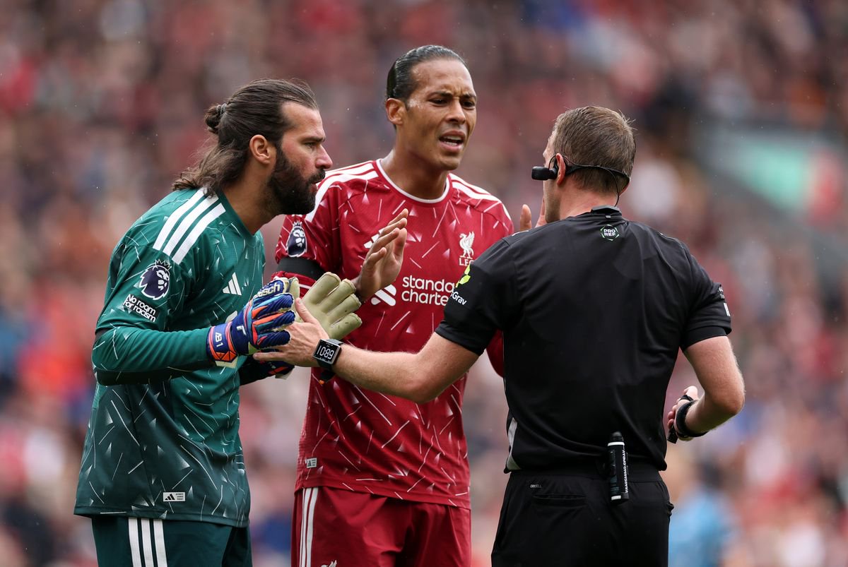Alisson Becker and Virgil van Dijk of Liverpool appeal to Referee Samuel Barrott after he awarded a penalty to Nottingham Forest during the Premier League 2026/27 match between Liverpool FC and Nottingham Forest FC at Anfield