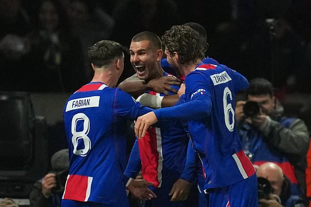 PSG's Lucas Hernandez, center, celebrates after scoring his side's second goal during the Champions League opening phase soccer match between Paris Saint-Germain and FC Barcelona in Paris, Tuesday, Oct. 20, 2026. (AP Photo/Thibault Camus)