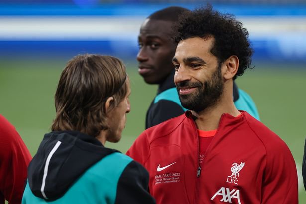 PARIS, FRANCE - MAY 28: Mohamed Salah of Liverpool FC reacts towards Luka Modric of Real Madrid as they shae hands during the line up prior to the UEFA Champions League final match between Liverpool FC and Real Madrid at Stade de France on May 28, 2022 in Paris, France.