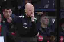 Erik ten Hag stands on the Vitality Stadium touchline with his hand on his chin.