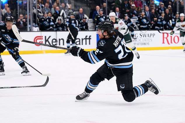 Utah Mammoth center Barrett Hayton (27) shoots the puck during the second period of an NHL hockey game against the Minnesota Wild, Tuesday, Oct. 27, 2026, in Salt Lake City. (AP Photo/Tyler Tate)