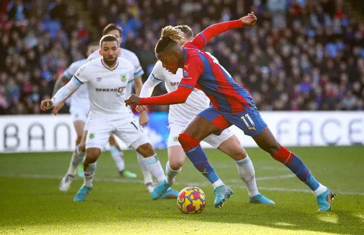 Wilfried Zaha of Crystal Palace runs with the ball during the Premier League match between Crystal Palace and Burnley 