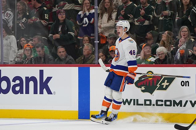 New York Islanders defenseman Matthew Schaefer (48) celebrates after scoring the winning goal during overtime of an NHL hockey game against the Minnesota Wild, Thursday, Oct. 29, 2026, in St. Paul, Minn. (AP Photo/Abbie Parr)
