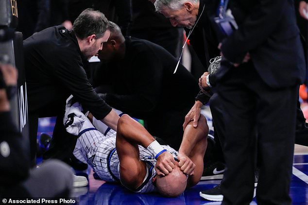 Orlando Magic guard Jalen Suggs, bottom, reacts after an injury during the second half of an NBA basketball game against the New York Knicks, Sunday, Oct. 25, 2026, in New York. (AP Photo/Yuki Iwamura)