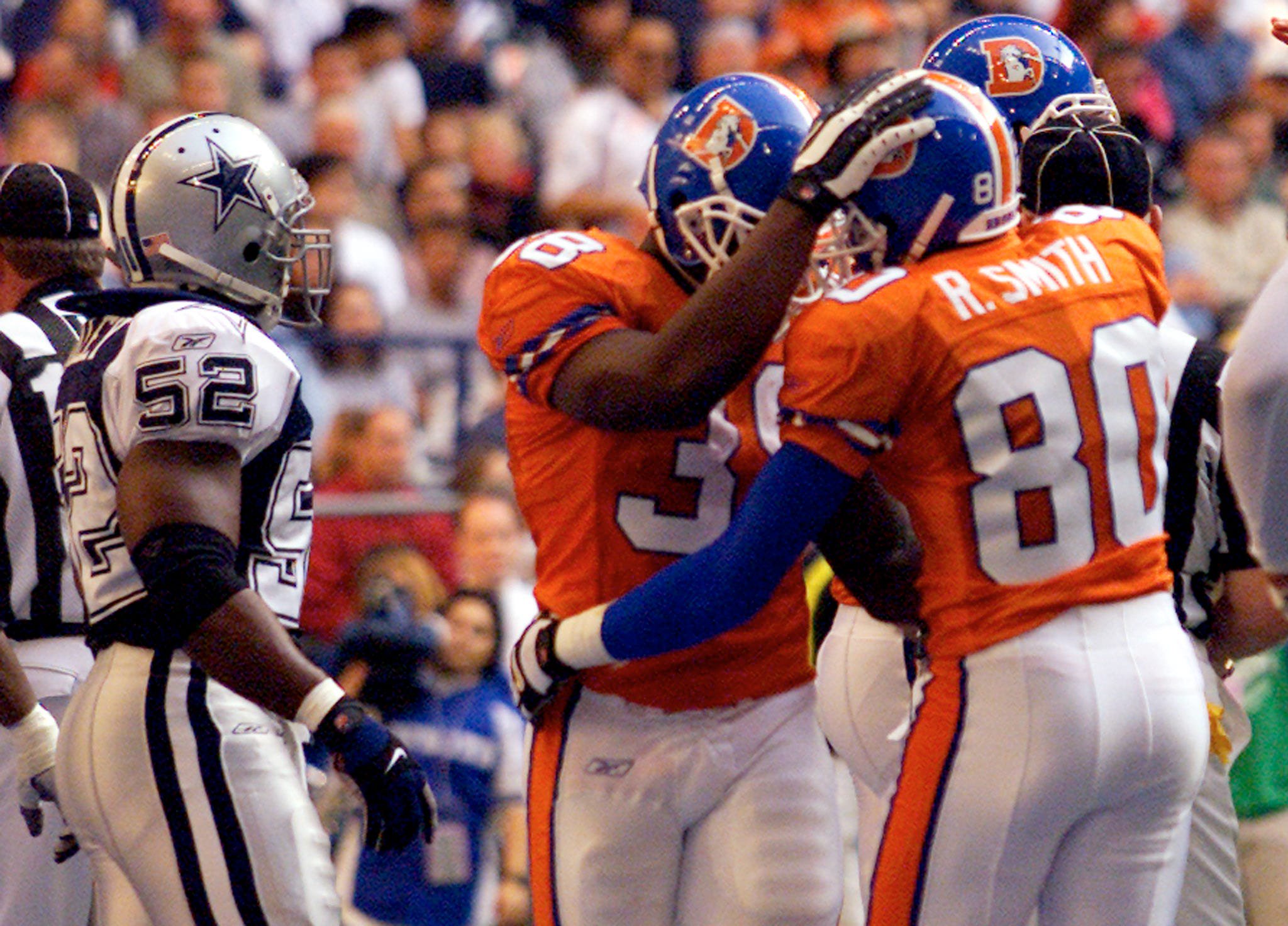 Denver Broncos wide receiver Rod Smith (R) congratulates running back
Mike Anderson (C) as Dallas Cowboys linebacker Dexter Coakley (L) walks
out of the end zone after Anderson scored a touchdown against the
Cowboys in the second quarter at Texas Stadium in Irving, November 22,
2001. This is the 34th year the Cowboys have hosted an NFL game on
Thanksgiving. REUTERS/Jeff Mitchell

JM/HK