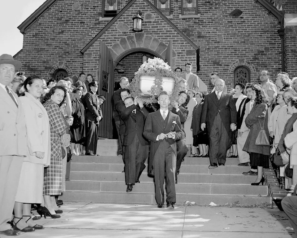 UNITED STATES - OCTOBER 08:  The coffin for slain gambler Willie Moretti is borne from Corpus Chirsti Church in Hasbrouck Heights, N.J., with an unruly mass of curiosity-seekers. In fact, the whole funeral from start to finish was a big show typical of the prohibition era's best send-offs for its rubbed-out members.  (Photo by Joe Petrella/NY Daily News Archive via Getty Images)