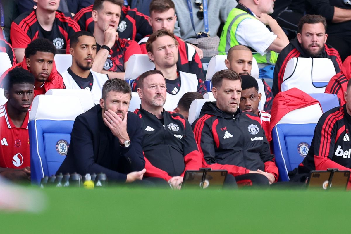 Michael Carrick, head coach / manager of Manchester United reacts as he sits alongside Steve Holland and Jonathan Woodgate 