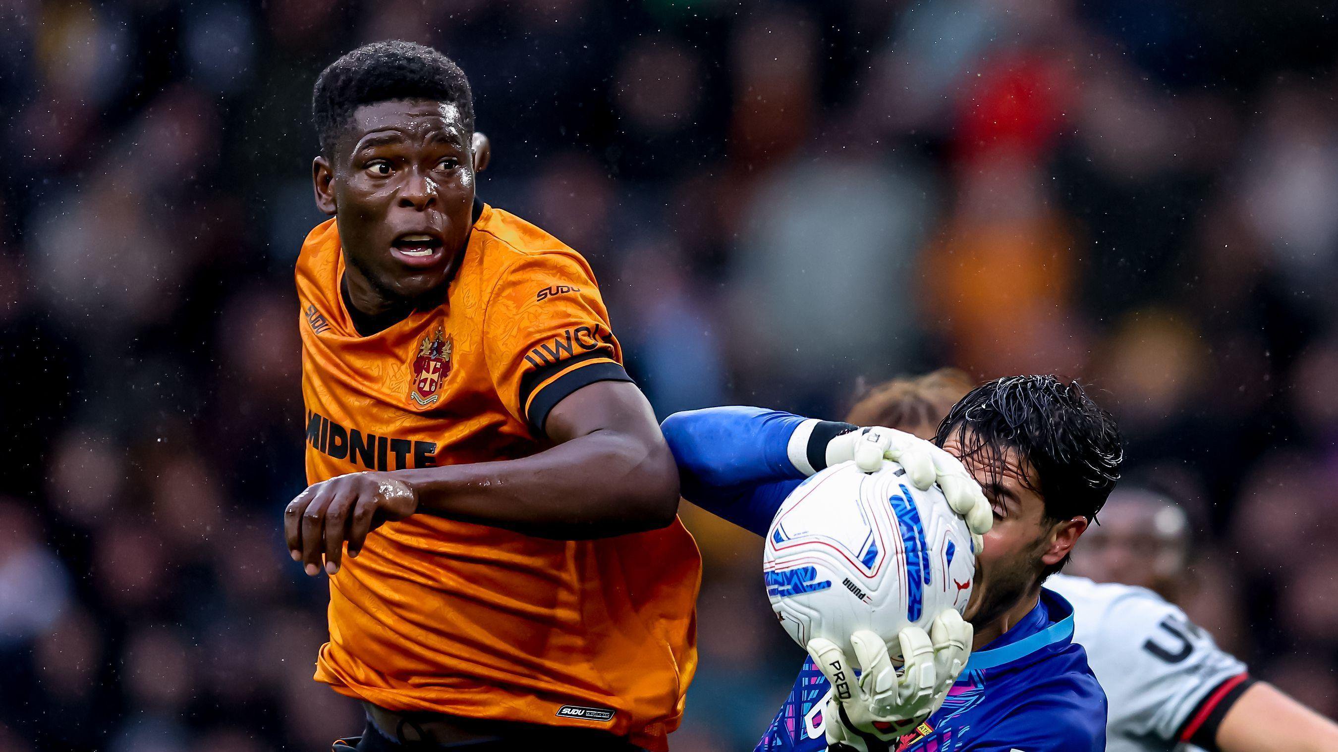 Marshall Munetsi (left) goes for goal during Wolves' game against Watford on Saturday
