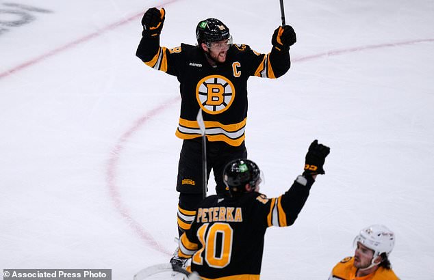 Boston Bruins' David Pastrnak, top, celebrates after his goal against the Nashville Predators during the second period of an NHL hockey game, Thursday, Oct. 22, 2026, in Boston. (AP Photo/Charles Krupa)