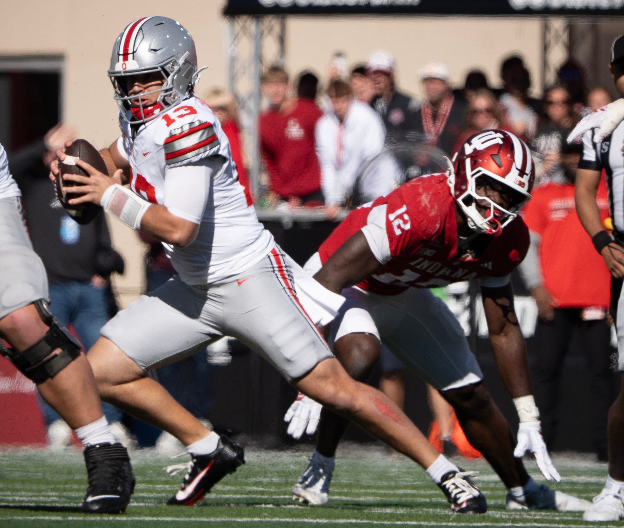 Ohio State's Luke Fahey (13) avoids Indiana's Tobi Osunsanmi (12) during the Indiana versus Ohio State football game at Memorial Stadium on Saturday, Oct. 17, 2026.