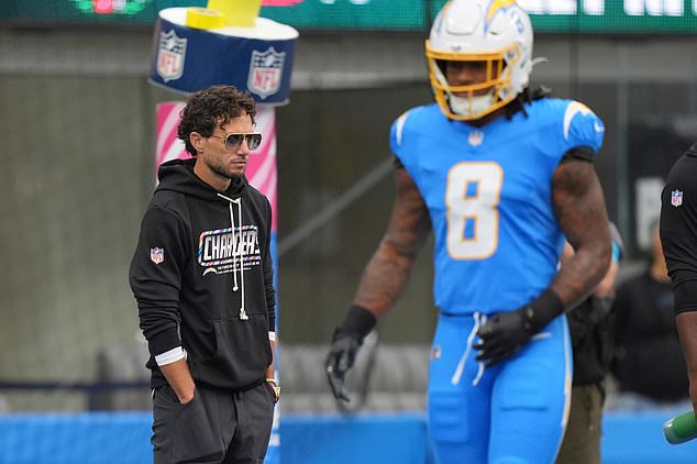 Los Angeles Chargers offensive coordinator Mike McDaniel, left, is seen on the field with running back Omarion Hampton prior to an NFL football game against the Denver Broncos, Sunday, Oct. 11, 2026, in Inglewood, Calif. (AP Photo/Scott Strazzante)