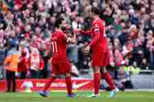 Mohamed Salah of Liverpool celebrates scoring his team's second goal with teammate Virgil van Dijk during the Premier League match between Liverpoo...