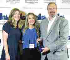 
			
				                                The City of Pittston Executive Director of the Citys Office of Community Development and Redevelopment Authority and City Manager, right, along with Redevelopment Authority Deputy Director Shannon Bonnacci, left, and Kristen Miller, Redevelopment Authority assistant/research analyst, center, received a project-based Townie Award for the Waterfront Warehouse on behalf of Waterfront Management Group LLC.
                                 Submitted photo

			
		