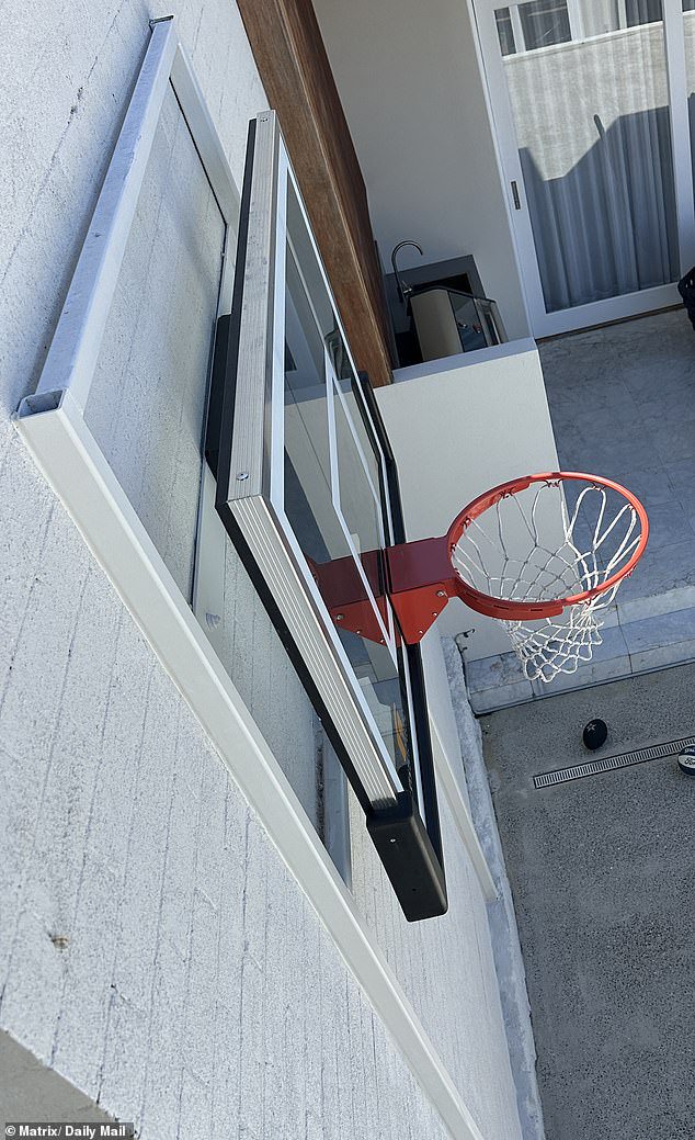 The basketball hoop above a mini backyard court is mounted to a wall shared with the neighbours of the Boguts¿ $3.8million mansion, which the 53-year-old renting the one-bedroom ground floor flat next door says has cost her sleep
