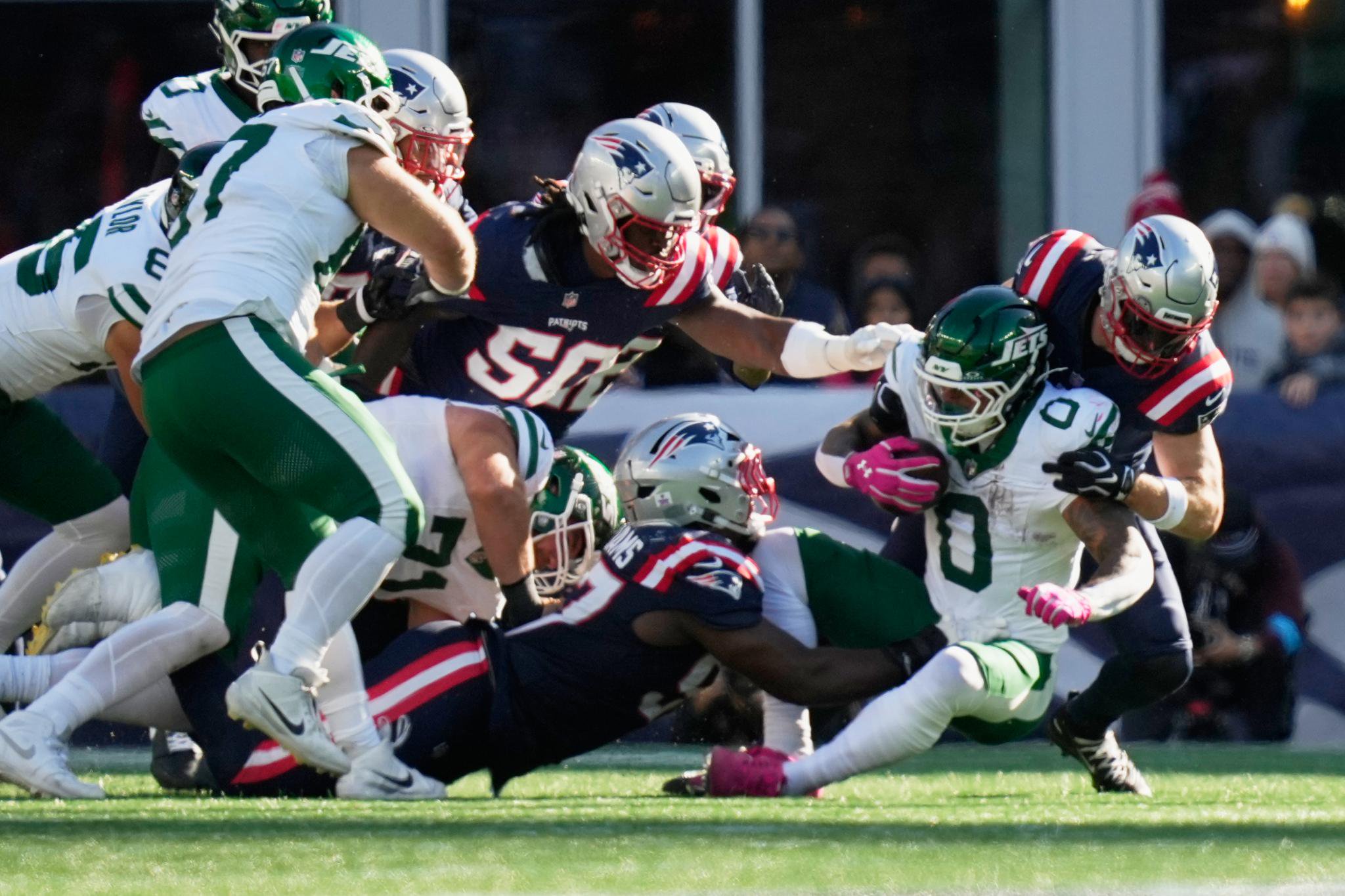 Jets running back Braelon Allen (0) is tackled during the second half of an NFL football game against the New England Patriots in Foxborough, Mass., Sunday, Oct. 18, 2026.