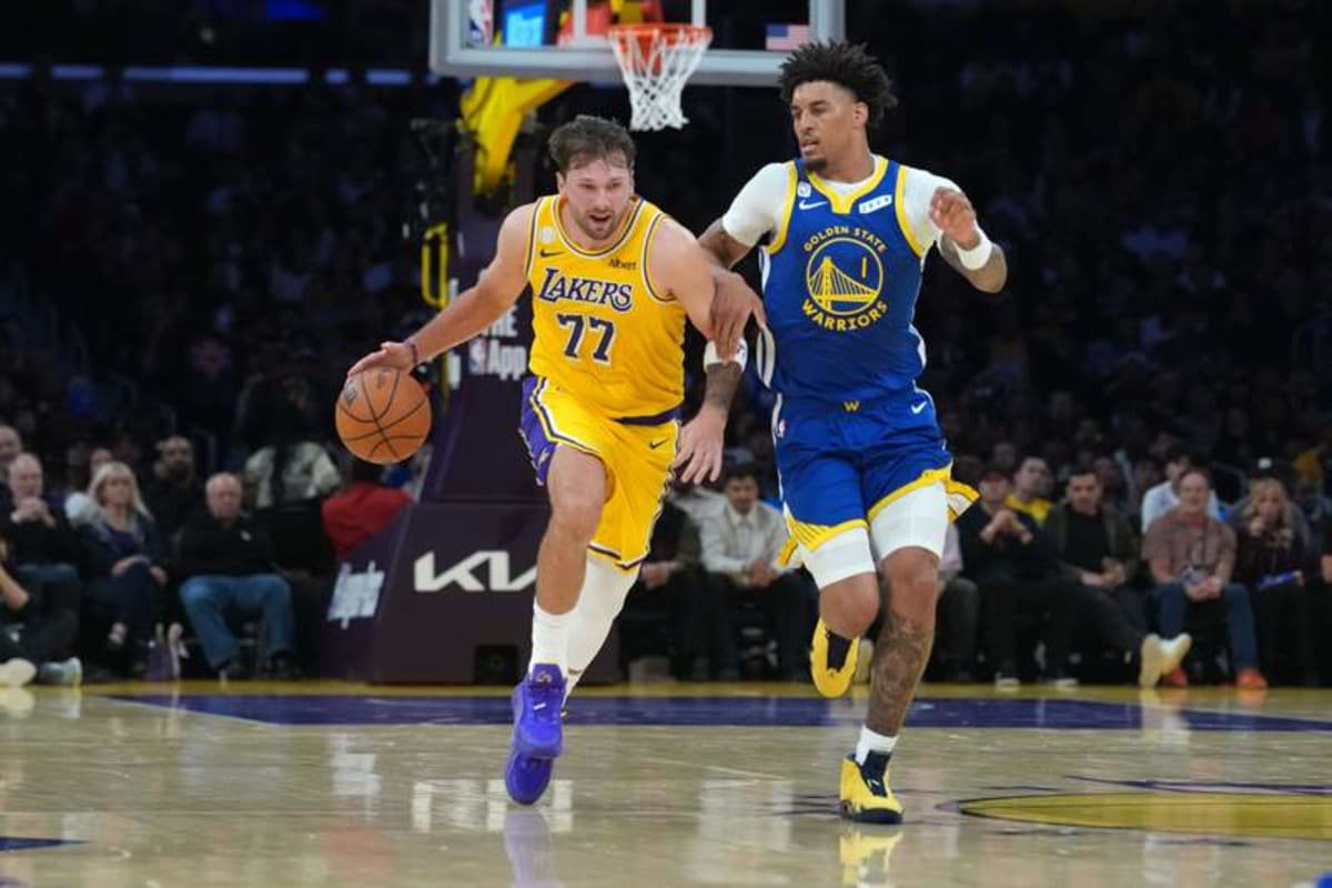 Oct 21, 2026; Los Angeles, California, USA; Los Angeles Lakers guard Luka Doncic (77) drives to the basket against Golden State Warriors forward Yaxel Lendeborg (1) in the first half at Crypto.com Arena. © Kirby Lee-Imagn Images