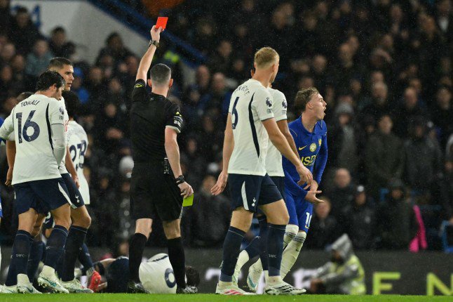 English referee Chris Kavanagh shows a red card to Chelsea's English midfielder #10 Cole Palmer (R) during the English Premier League football match between Chelsea and Tottenham Hotspur at Stamford Bridge in London on October 24, 2026. (Photo by Glyn KIRK / AFP via Getty Images) / RESTRICTED TO EDITORIAL USE. No use with unauthorized audio, video, data, fixture lists, club/league logos or 'live' services. Online in-match use limited to 120 images. An additional 40 images may be used in extra time. No video emulation. Social media in-match use limited to 120 images. An additional 40 images may be used in extra time. No use in betting publications, games or single club/league/player publications. /