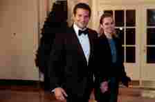 WASHINGTON, DC – FEBRUARY 11:  Actor Bradley Cooper, left, and Suki Waterhouse arrive to a state dinner hosted by U.S. President Barack Obama and U.S. first lady Michelle Obama in honor of French President Francois Hollande at the White House on February 11, 2014 in Washington, DC. Obama and Hollande said the U.S. and France are embarking on a new, elevated level of cooperation as they confront global security threats in Syria and Iran, deal with climate change and expand economic cooperation. (Photo by Andrew Harrer-Pool/Getty Images)
