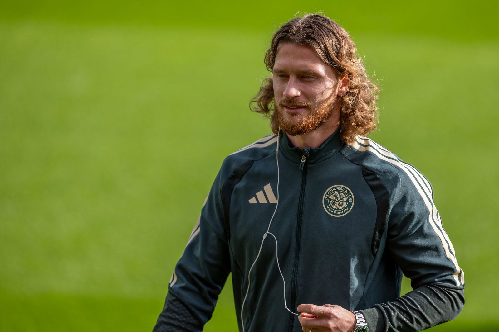Celtic players walk the Fir Park pitch before kick-off against Motherwell