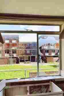 Picture through window from inside one of flats onto outside of estate.