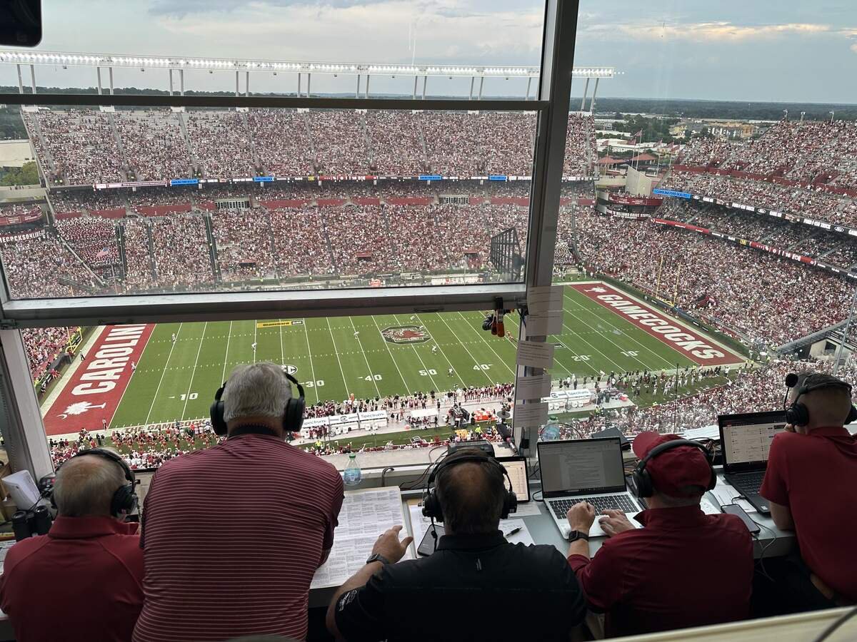 Todd Ellis (middle) calls South Carolina football’s game vs Mississippi State in 2026 from the booth in Williams-Brice Stadium surround by his support crew of Tommy Suggs (left), David Spence (middle left), Doug Adams (middle right) and Chris Miller (right).