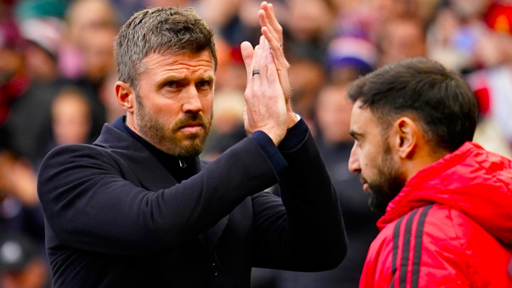 Manchester United's head coach Michael Carrick applauds supporters while Bruno Fernandes looks on ahead of the start of the English Premier League match between Manchester United and Bournemouth. (AP Photo)