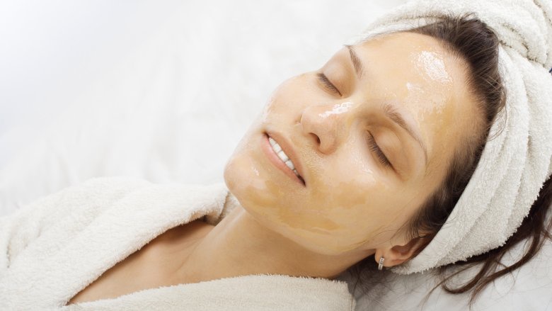 woman with a honey mask on her face