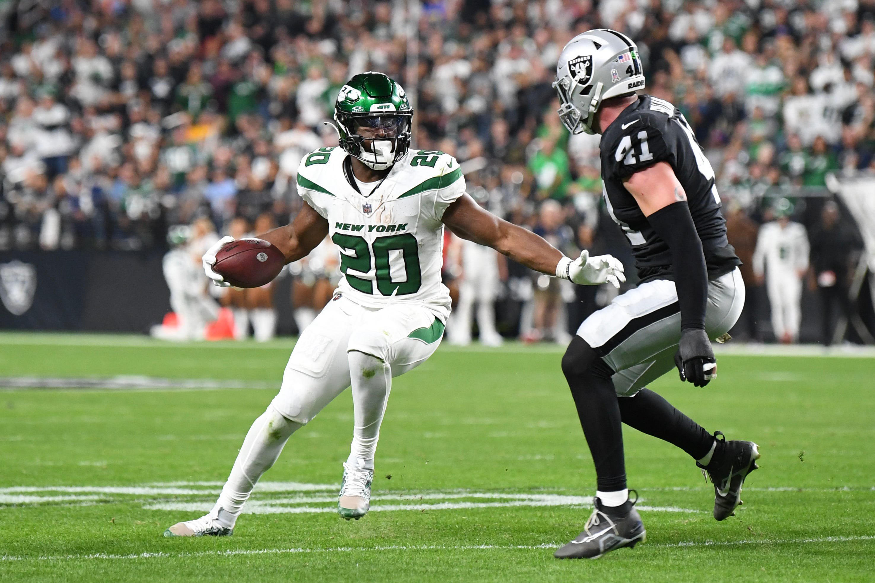 Nov 12, 2023; Paradise, Nevada, USA; New York Jets running back Breece Hall (20) is defended by Las Vegas Raiders linebacker Robert Spillane (41) in the second quarter at Allegiant Stadium. Mandatory Credit: Candice Ward-USA TODAY Sports