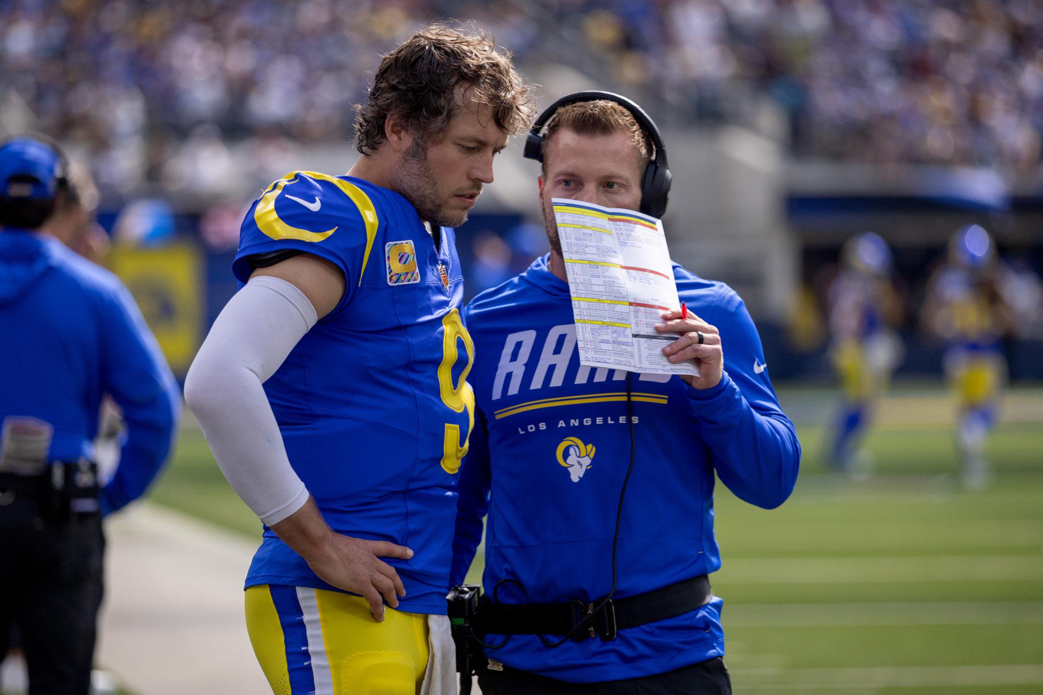 Los Angeles Rams quarterback Matthew Stafford and coach Sean McVay conferring on the sideline.