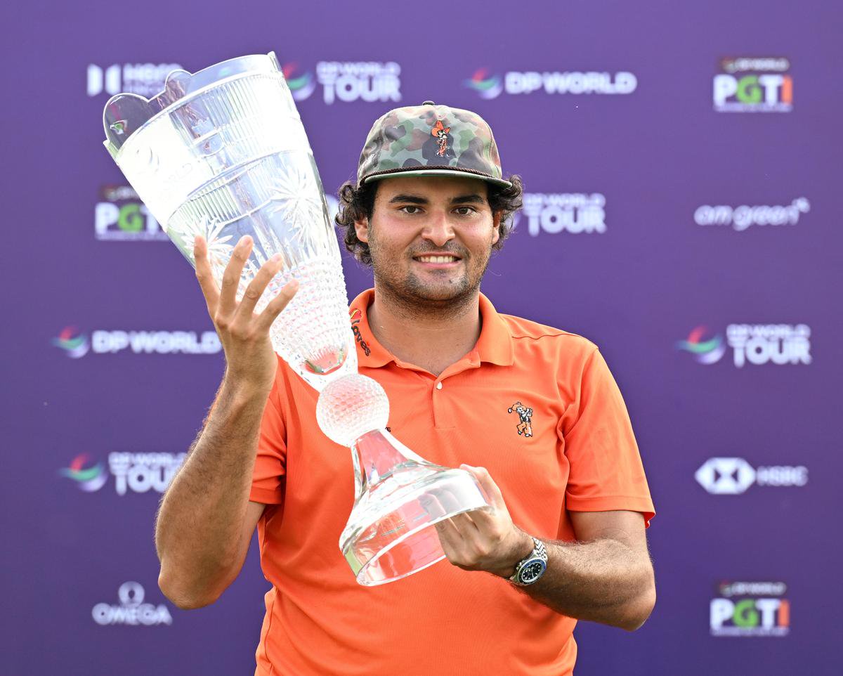 Eugenio Chacarra poses with the the DP World India Golf Championship trophy.