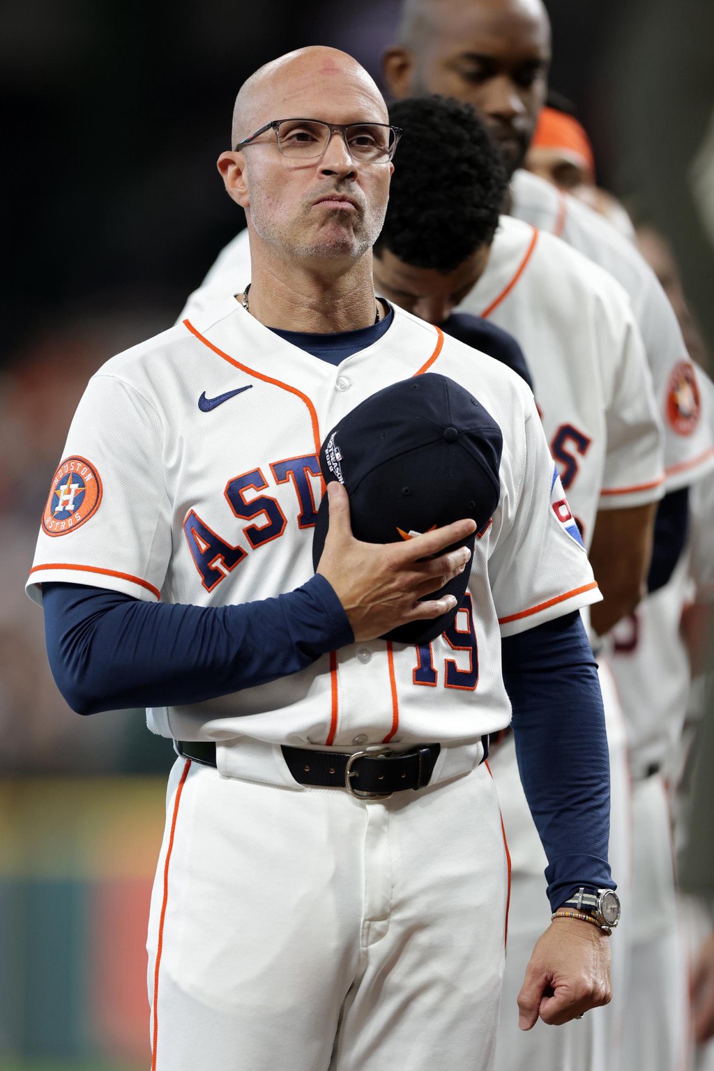 Houston Astros manager Joe Espada holds his cap to his chest during the national anthem.
