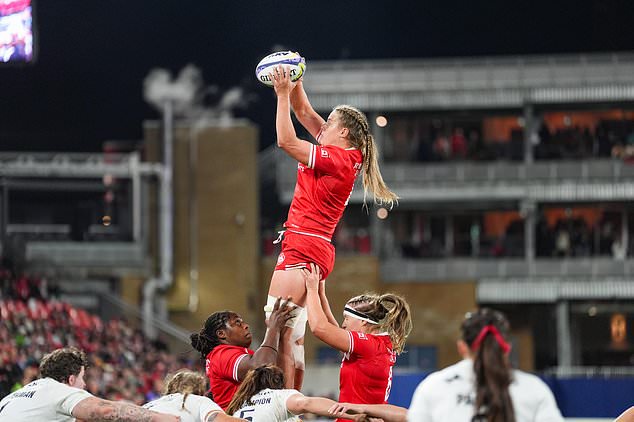 Canada's Sophie de Goede, top, is lifted up by teammates during the first half of a women's rugby match against England in Toronto, Friday, Oct. 16, 2026. (Arlyn McAdorey/The Canadian Press via AP)