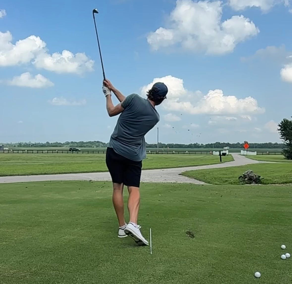 Adam Schenk hits a shot at the family sod farm in Vincennes, Indiana, where he learned to play the game.