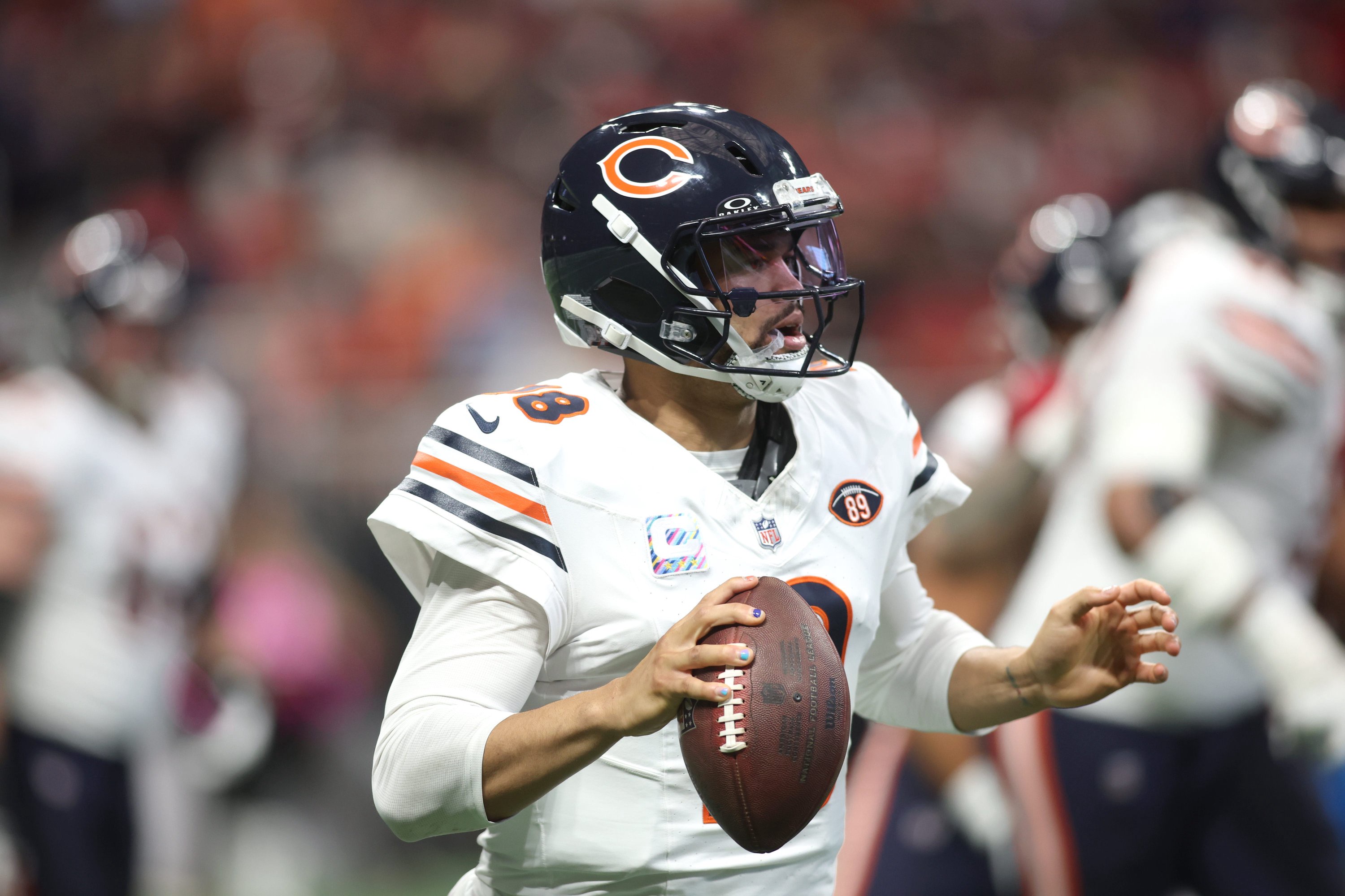 Chicago Bears quarterback Caleb Williams (18) eludes the Atlanta Falcons rush during the second quarter at Mercedes-Benz Stadium.