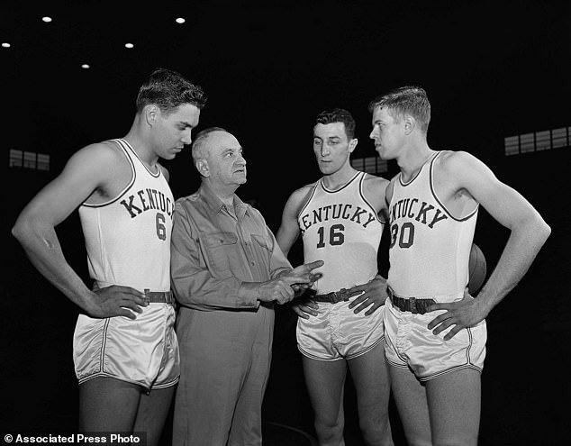 Kentucky basketball coach Adolph Rupp talks to players, from left, Cliff Hagan, Lou Tsioropoulos and Frank Ramsey (30) in Lexington, Kentucky on January 16, 1954