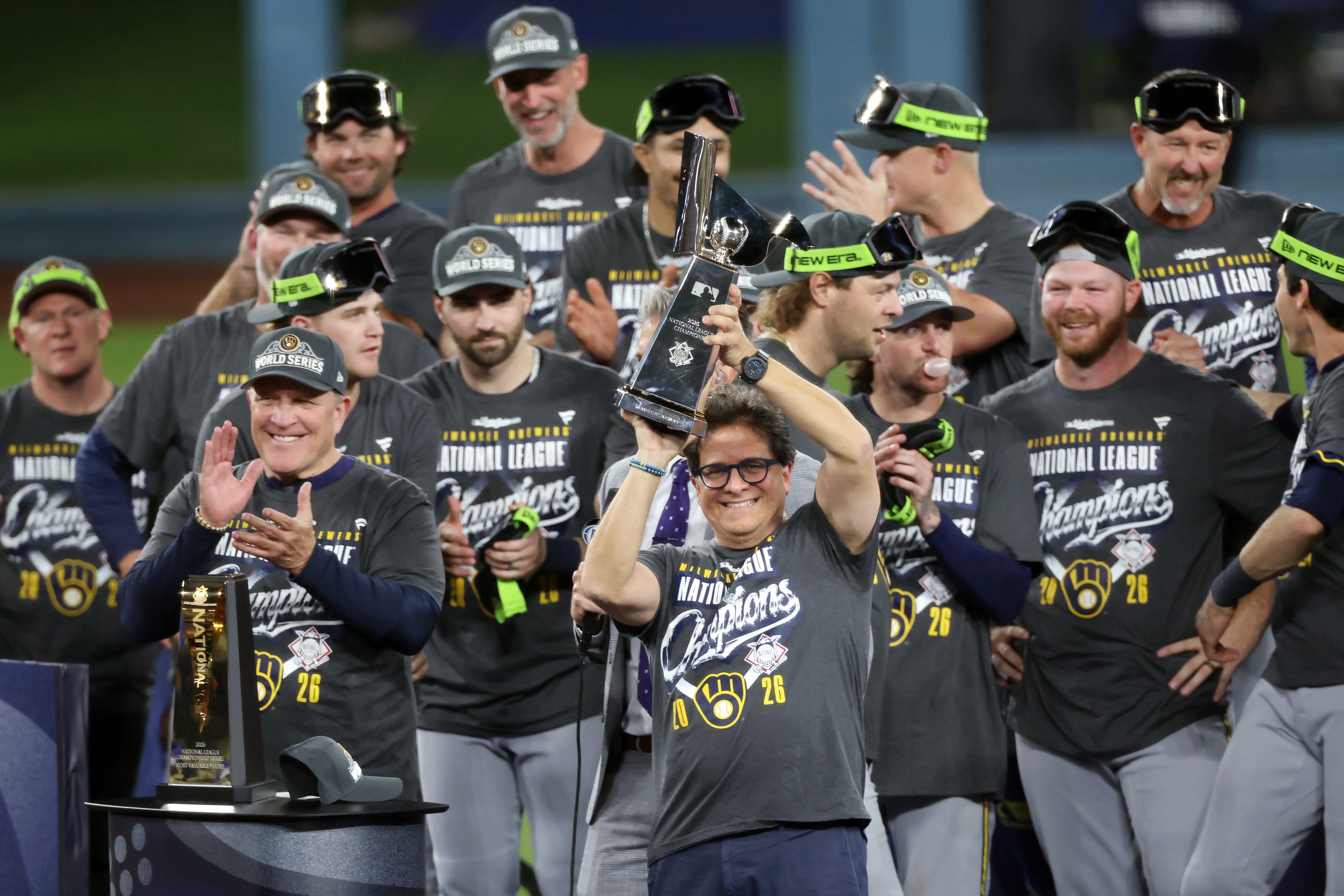 Milwaukee Brewers owner Mark Attanasio is presented with the Warren C. Giles Trophy after his team defeated the Los Angeles Dodgers in Game 4 of the National League Championship Series on Oct. 15, 2026, at Dodger Stadium in Los Angeles.
