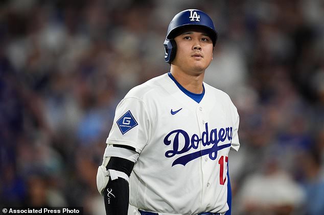 Los Angeles Dodgers designated hitter Shohei Ohtani walks to the dugout after striking out during the seventh inning of Game 4 of baseball's National League Championship Series between the Milwaukee Brewers and the Los Angeles Dodgers, Thursday, Oct. 15, 2026, in Los Angeles. (AP Photo/Gregory Bull)