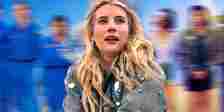 Emma Roberts as Rex looking wowed against Space Cadet poster background
