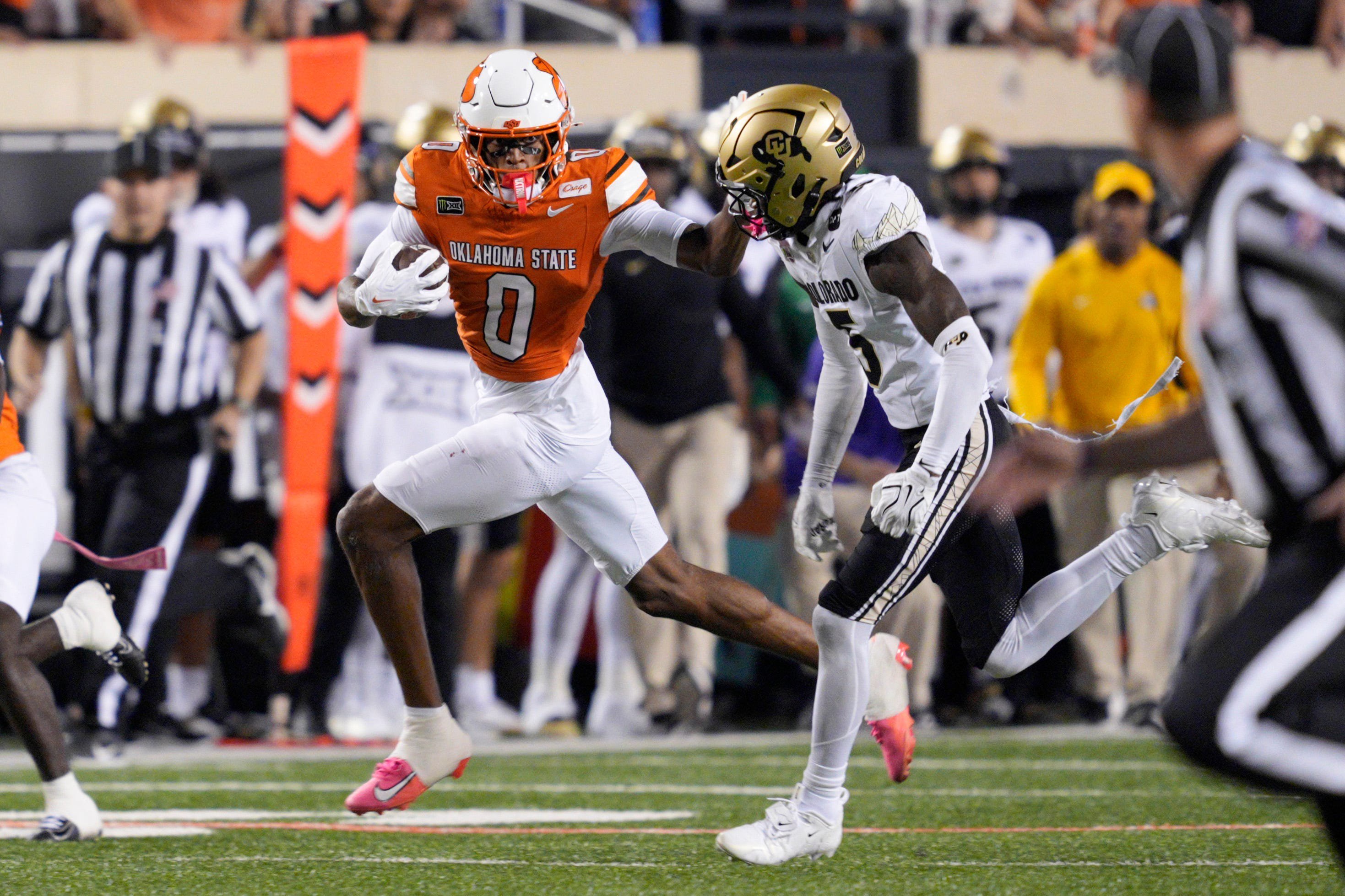 Oklahoma State Cowboys wide receiver Justin Bowick (0) runs beside Colorado Buffaloes defensive back RJ Johnson (5) after a reception during a college football game between the Oklahoma State Cowboys (OSU) and the Colorado Buffaloes at Boone Pickens Stadium in Stillwater, Okla., Saturday, Oct. 24, 2026. Oklahoma State won 57-24.
