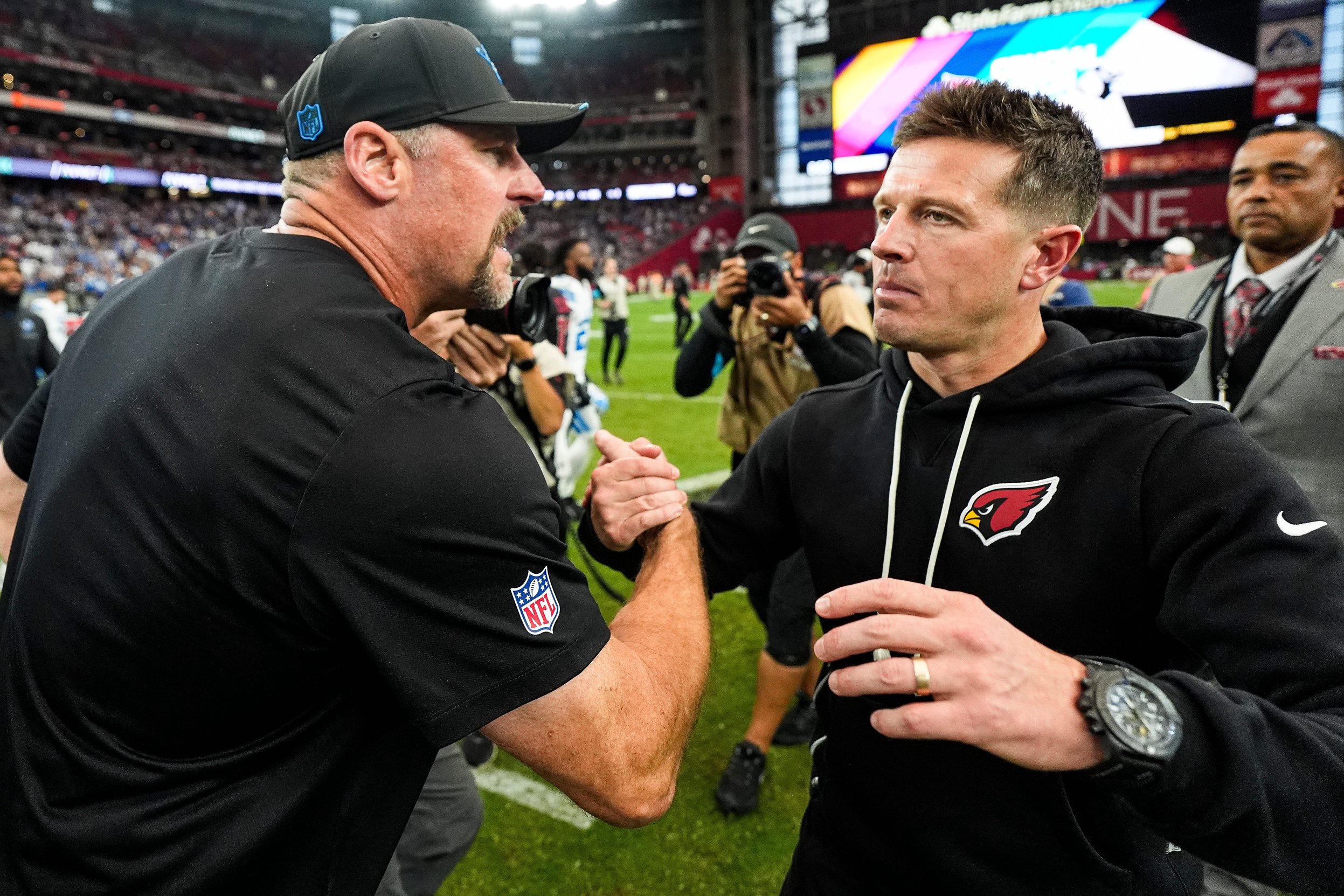 Detroit Lions head coach Dan Campbell, left, shakes hands with Arizona Cardinals head coach Mike LaFleur after a 45-21 win over the Arizona Cardinals at State Farm Stadium in Glendale, Arizona, on Sunday, Oct. 11, 2026.