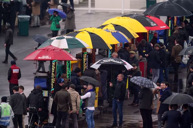 Racegoers place bets at bookmaker stands