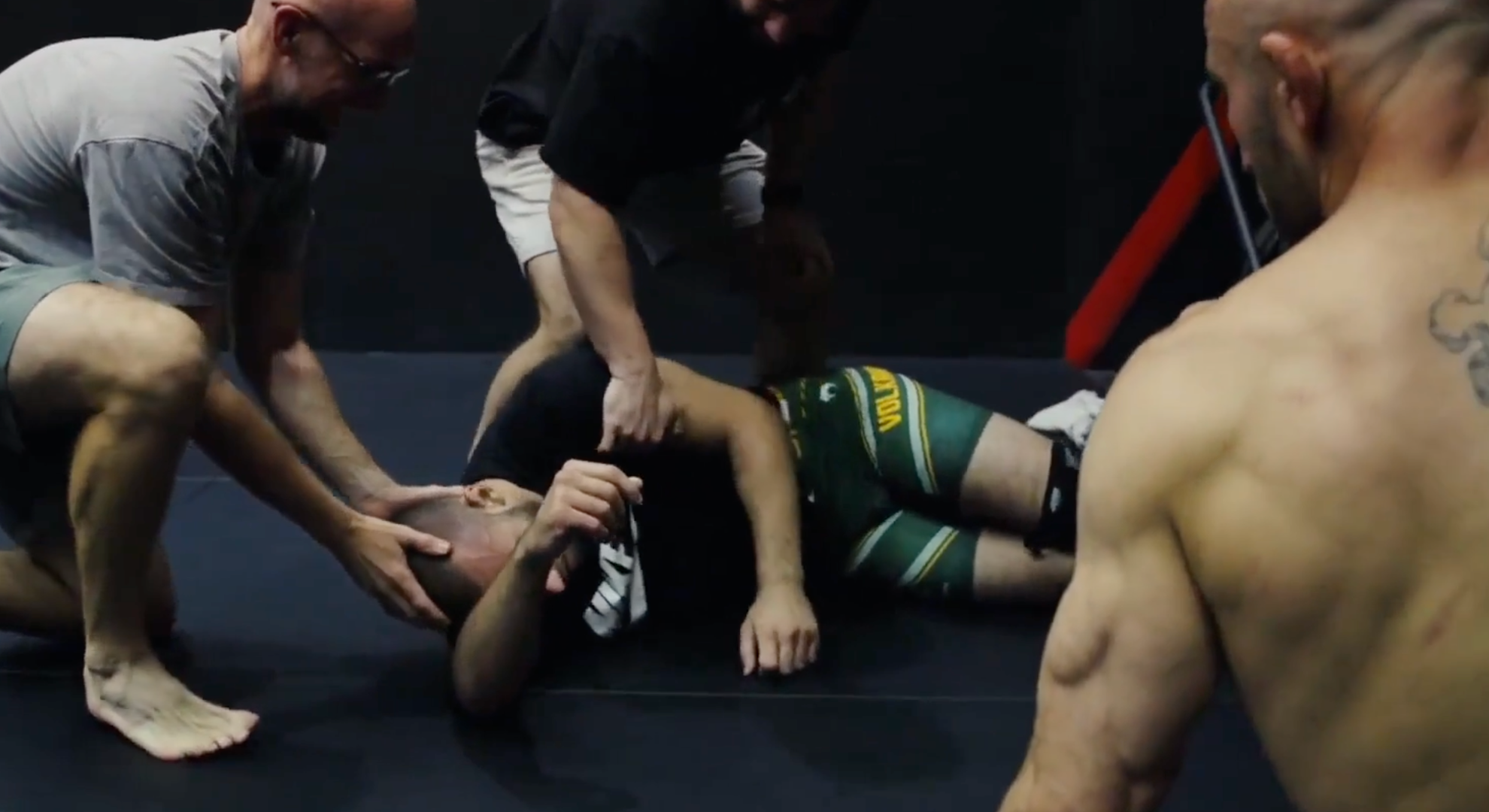 Alexander Volkanovski watches over his unconscious teammate